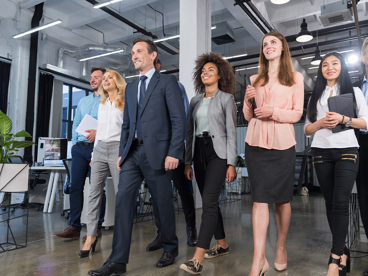 Person talking to a group of employees.
